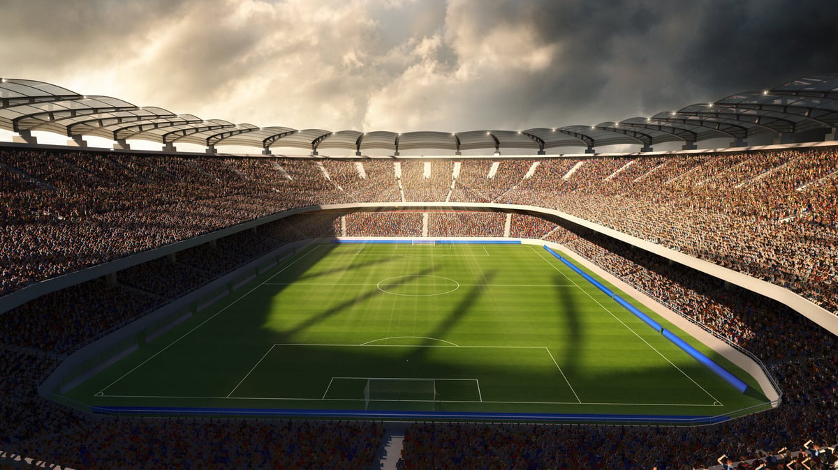 A stadium filled with fans under dramatic evening light